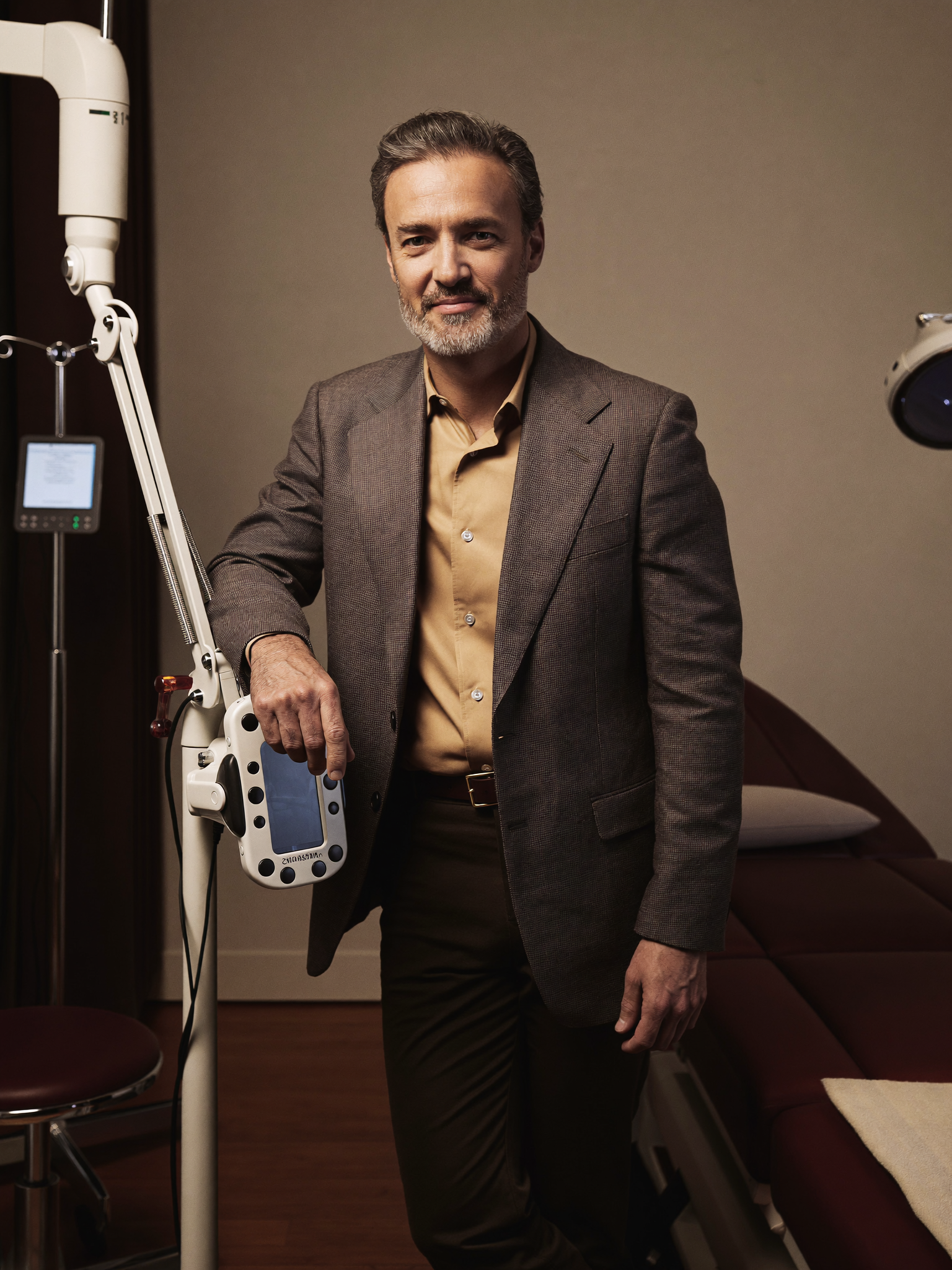 Dr. Marcus Hale, a board-certified facial plastic surgeon, in his discreet consultation room