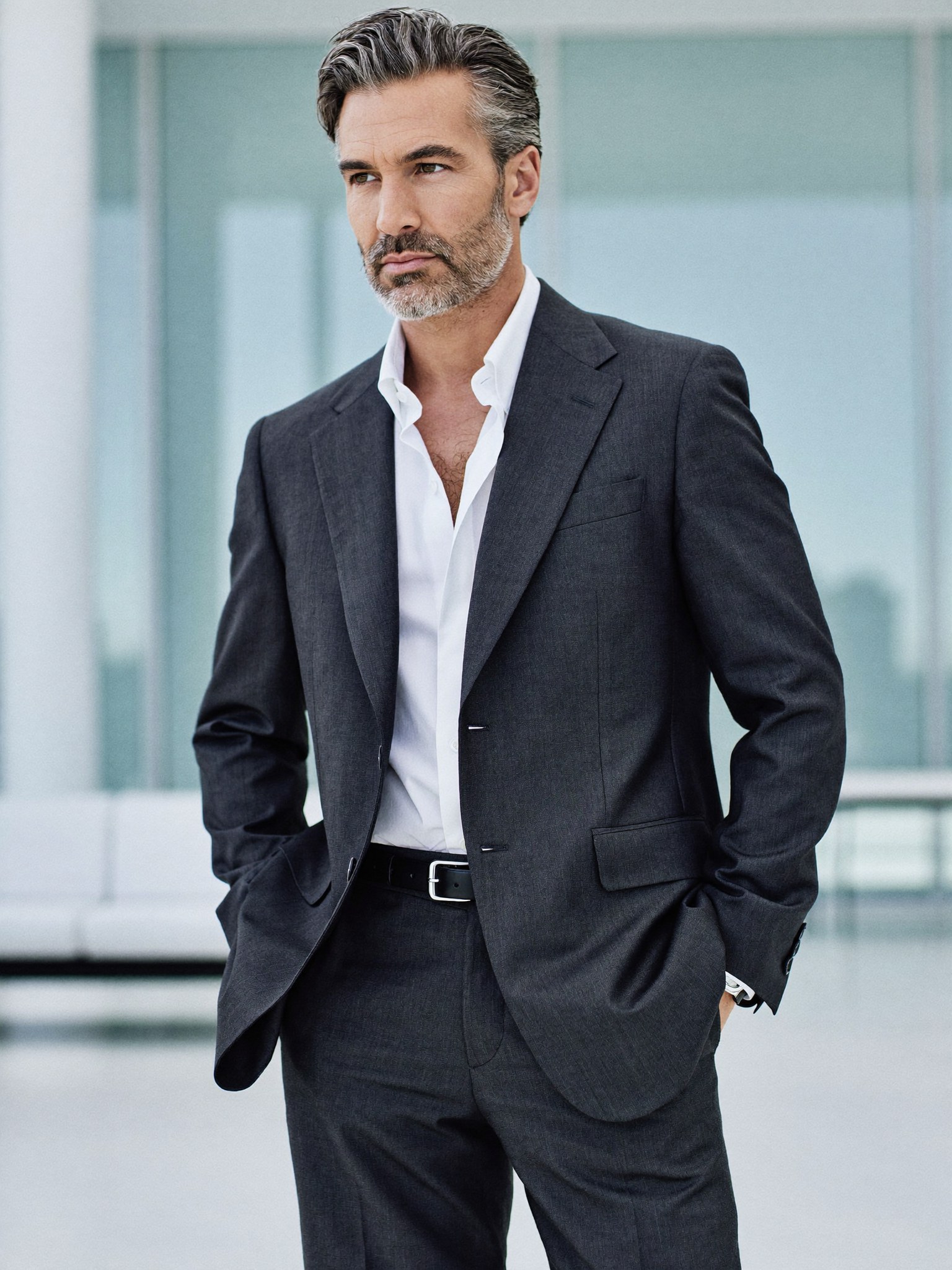 A distinguished professional man in his fifties, rested and sharp in a tailored suit, fully dressed