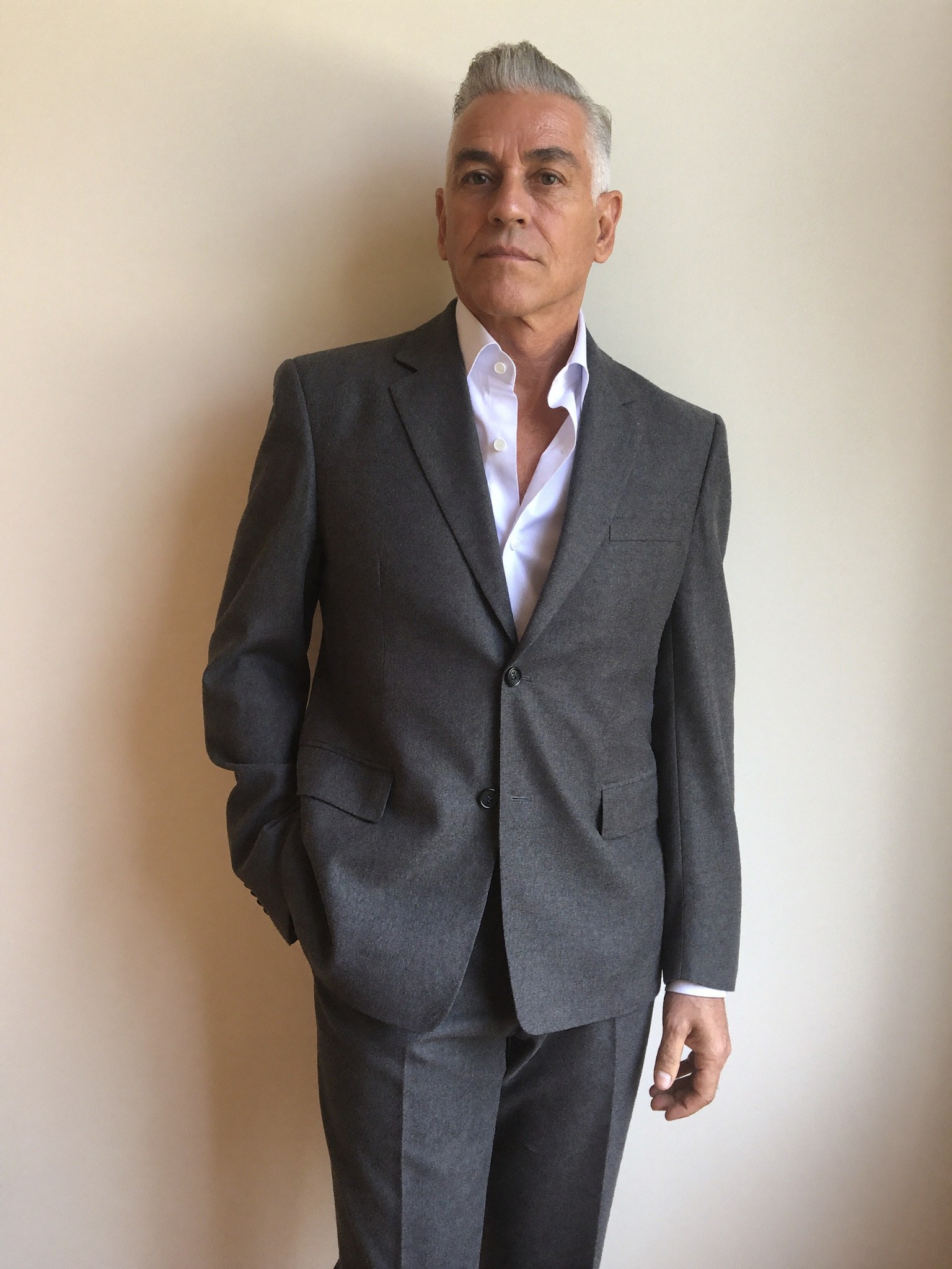 A composed, well-dressed professional man in natural light — rested, alert, and still unmistakably himself.